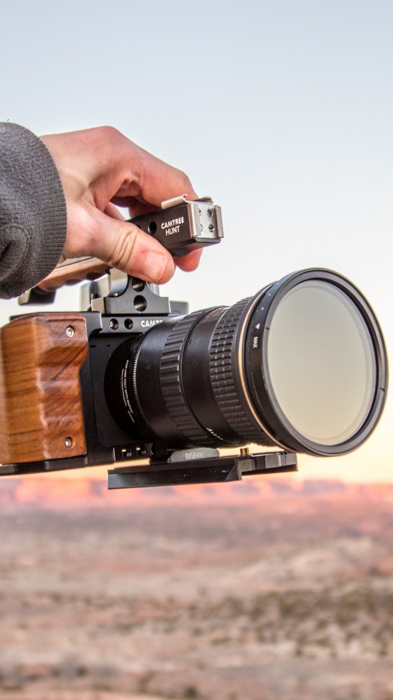 Camera held up at sunset